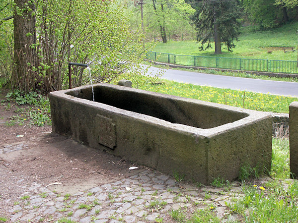 Old stone fountain in Krásný Buk.