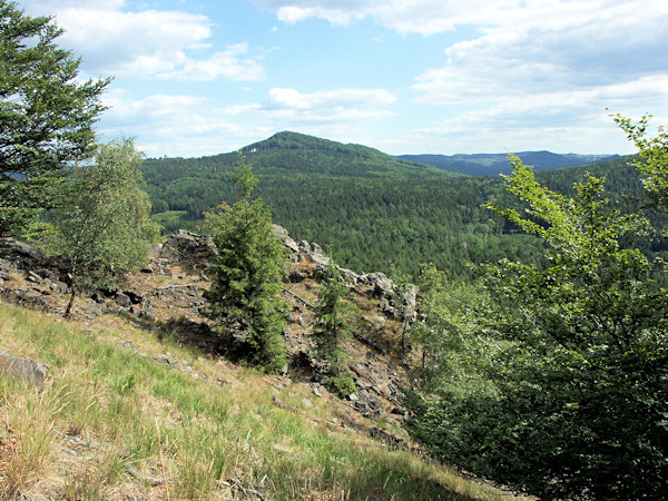 View from the Chřibský vrch to the Javor hill. In the background there is the flat ridge Klučky.