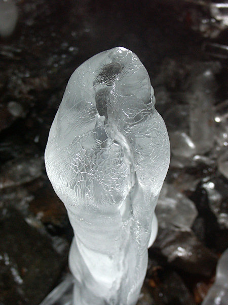 An icicle with its top corroded by dropping water.