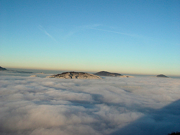 As distant isles the Velký Buk-Mt (in the north) and behind of it the Pěnkavčí vrch and in the extreme right the Luž-Mt are protruding over the clouds.