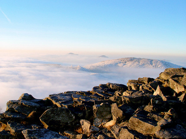 The rays of the descending sun illuminate the Malý Buk Mt. and the more distant peaks of the Javor and Studenec Mts.