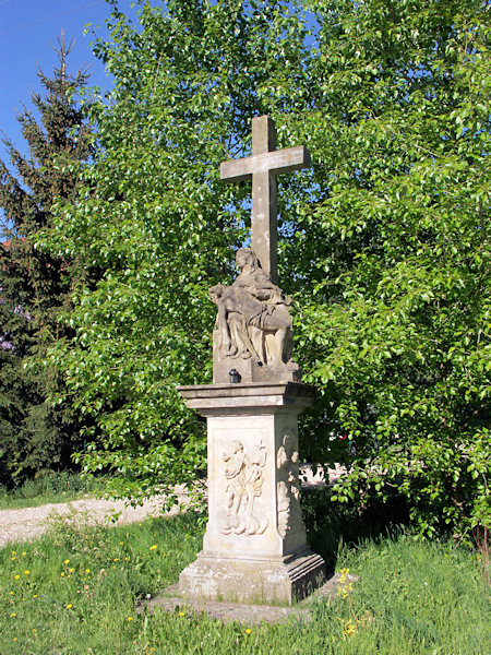 A stone cross with Pieta behind the railway station Rynoltice.