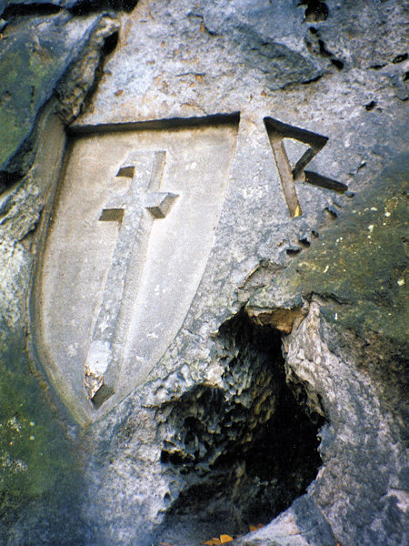 A coat-of-arms chiselled into the rock above the Švédská díra cave near Sloup.
