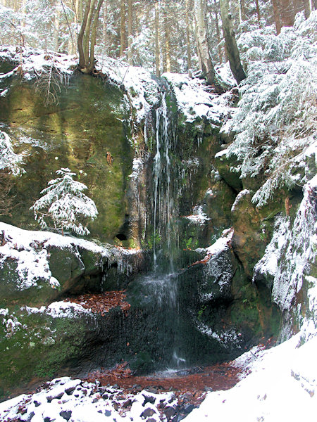 Waterfall in Luční potok valley in winter.