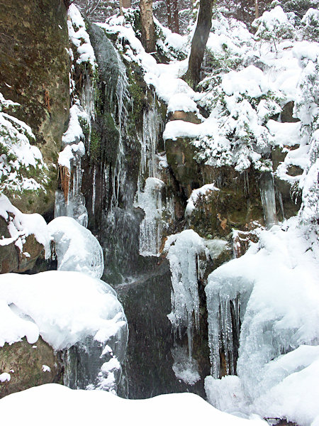 Waterfall in Luční potok valley in winter.