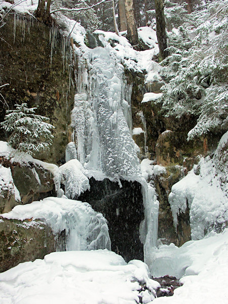 Waterfall in Luční potok valley in winter.