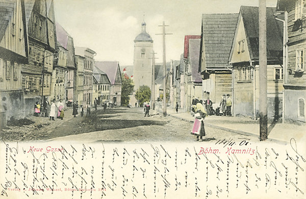 On this picture postcard from 1901 there is the former Nová ulice (New Street) built after 1658 as seen to the south from the castle's gate. Till the middle of the 20th century several wooden houses remained here. In the background there is the tower of St. James'.