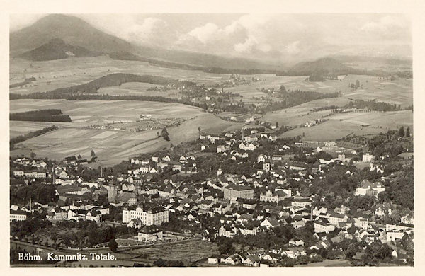 This picture postcard shows the town in the view from the Zámecký vrch hill. In the background there is the settlement Filipov and on the left side the Růžovský vrch is protruding from the background.