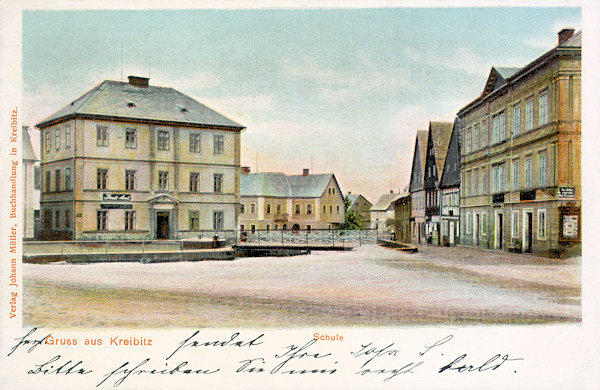 On this picture postcard from the turn of the 19th and 20th century the northwestern corner of the market-place is shown with the building which as before also at present serve the municipality (left). The schoolhouse standing in the background survived to the present days although with a changed outlook.