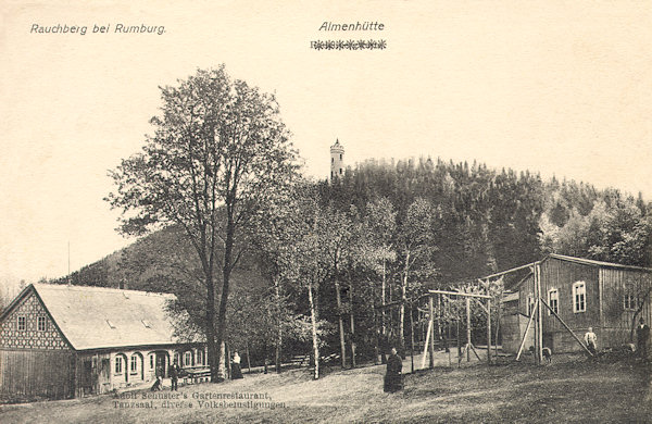 This picture postcard from the years from the World War One shows the Dymník with its look-out tower and the restaurant „Almenhütte“ which formerly was named „Rauchbergschänke“.