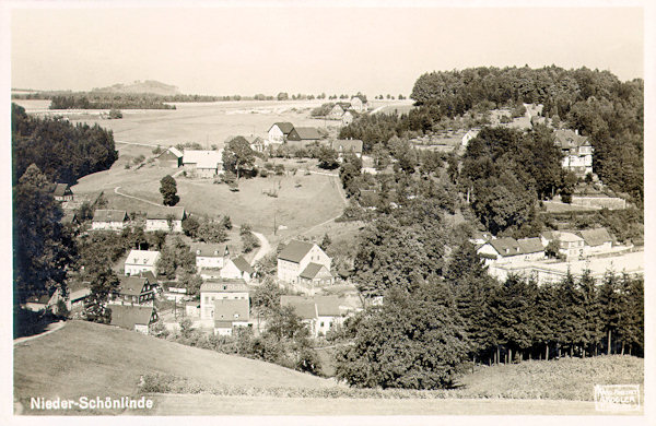 This picture postcard from 1931 shows the lower part of Krásná Lípa in the valley of the Křinice-brook as seen from the hill near the Fibichovo údolí-valley. In the left side of the background the Dymník hill is seen.