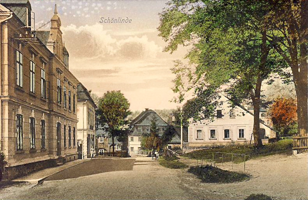 This picture postcard shows the Kyjovská ulice-street. The three houses in the foreground are yet standing, but the great building in the background no more exists.