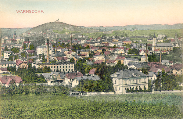 This picture postcard shows the town as seen from the Šibeniční vrch-hill not long before 1910. To the right there is the Old Catholic church, to the left in the background over the houses protrudes the tower of the church St. Peter and Paul on the town square and behind the town rises the Hrádek-hill with its excursion restaurant.