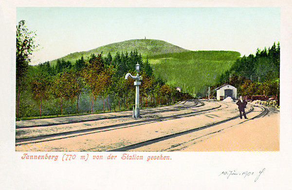 On this picture postcard from the turn of the 19th and 20th century there is the railway station Jedlová and in the background the hill with the same name. The station had then only four tracks between two of them a water crane was standing. In the background there is the later demolished locomotive shed.