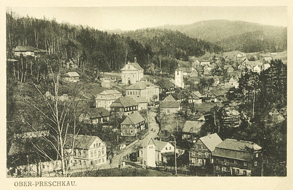 This picture postcard shows the central part of Horní Prysk with the church of St. Peter and Paul.