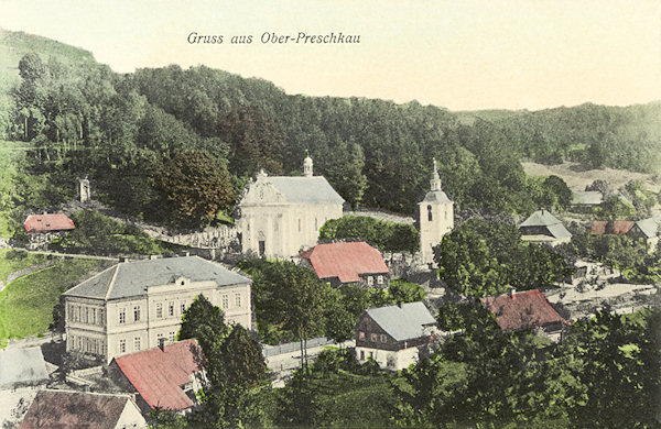 This picture postcard fshows the surroundings of  the church of St. Peter and Paul with its bell-tower. In the foreground there is the monumenal building of the former school and behind it the rock „Kalich“ (goblet) with a niche where in former times ther was a picture of the Coronation of the Mother of God.