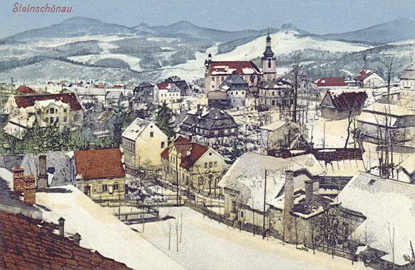 A postcard from 1912 showing a winter-time view of the central part of Kamenický Šenov and the peaks of the Lusatian Mountains.