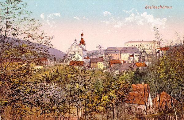 Auf dieser Ansichtskarte von Kamenický Šenov (Steinschönau) aus der Zeit um 1912 sieht man die Kirche St. Johannes des Täufers mit den umgebenden Häusern und der Schule im Hintergrunde.