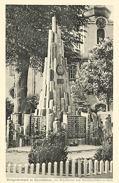 This picture postcard shows the war memorial in the park at the church after its completion by tables containing the names of the soldiers killed in World War One.