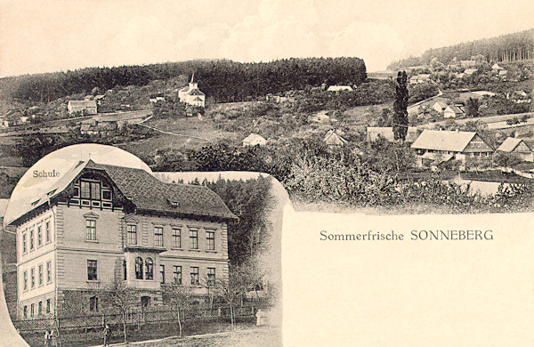 This picture postcard from 1919 shows the lower part of the village Slunečná with the church of the Assumption of Virgin Mary. The great building shown in the lower part of the card is the schoolhouse from 1889.