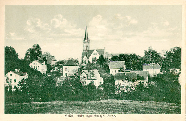 Tato pohlednice zachycuje evangelický kostel z roku 1902 s okolními domky, postavenými ve 20. letech 20. století.