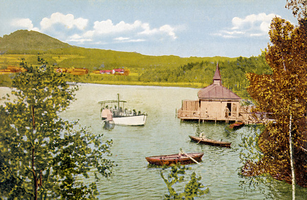 Auf dieser Ansichtskarte vom Jahre 1927 ist der Radvanecký rybník (Bretteich), der damals romantisch als Vlaštovčí jezero (Schwalbensee) bezeichnet wurde, mit seinem Freibad. Im Hintergrund ist der Berg Strážný (Wachberg).