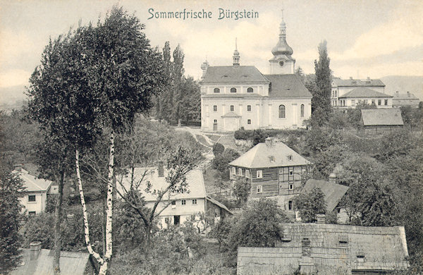 This picture postcard of the village Sloup shows the houses in the valley below the church of St. Catherine.