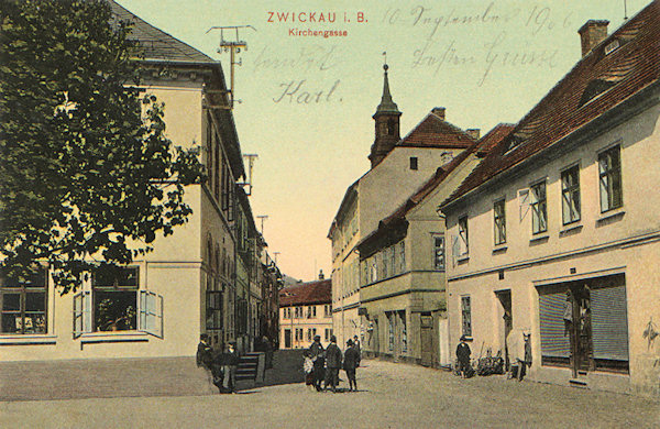 Tato pohlednice zachycuje starou Kostelní ulici u náměstí. Zatímco domy s bývalou radnicí na pravé straně tu stojí dodnes, celá levá strana byla kvůli rozšíření ulice v roce 1978 zbořena a tvář města tak utržila další hlubokou jizvu.