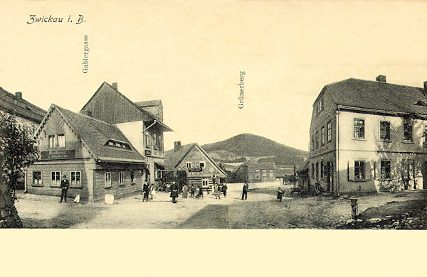 On this picture postcard the old road to Jablonné near of the bridge over the Boberský potok brook is shown. Almost all the houses shown were later demolished, at present remains only the two-storeyed house at the right corner. In the background there is the Zelený vrch hill.