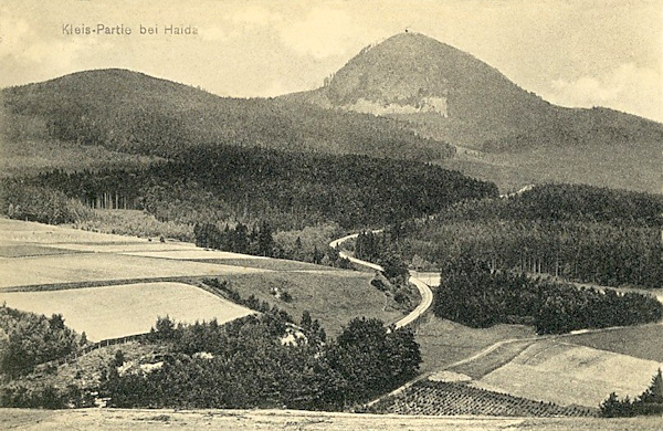 On this picture postcard from the years before World War One we see the Klíč-hill from the south. We see also the railway winding through the woods in the direction to Rumburk.
