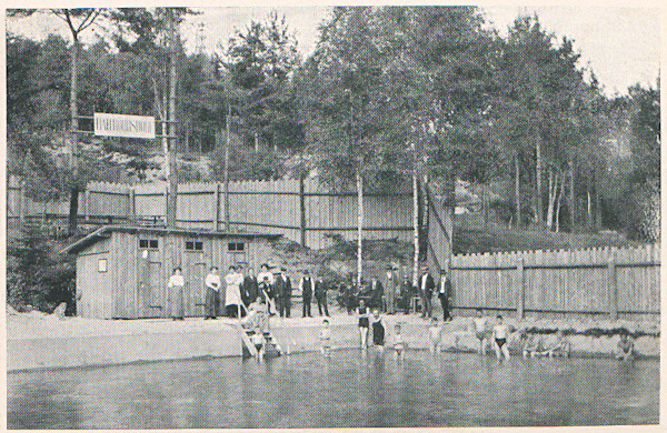 This picture postcard shows the swimming-pool located in the woods at the path to Rousínov.