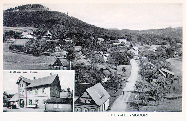 On this picture postcard you see the houses of the upper part of the village along the road to Krompach. In the cut below there ist the inn „Zur Sonne“ founded in 1873 which till the end of the war was owned by the family Heinrich. At the left side over the village there is the Zámecký vrch (Castle hill).