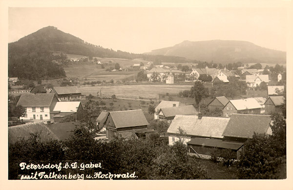 On this picture postcard from the years between the World Wars shows the southern part of Petrovice with its baroque bell tower (in the centre). Behind the village to the left there is the Sokol hill and behind it on the background the Hvozd-hill.