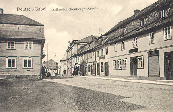 On this picture postcard from the beginning of the 20th century the beginning of the road leading to Liberec and to Zittau in Germany then called Zittau-Reichenberger Strasse in the town square is seen.