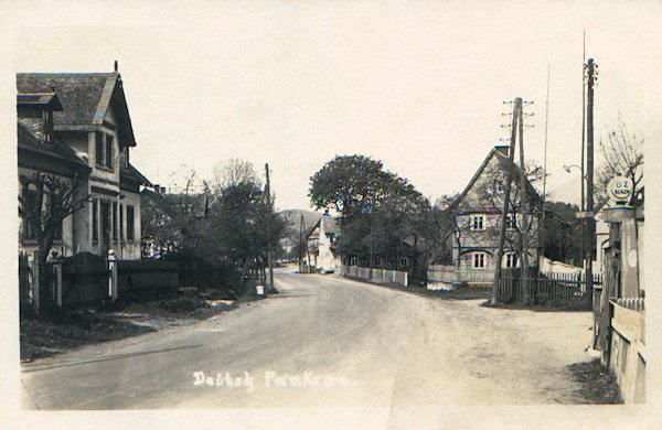 This picture postcard shows the houses in the lower part of the village along of the old road to Jablonné v Podještědí.