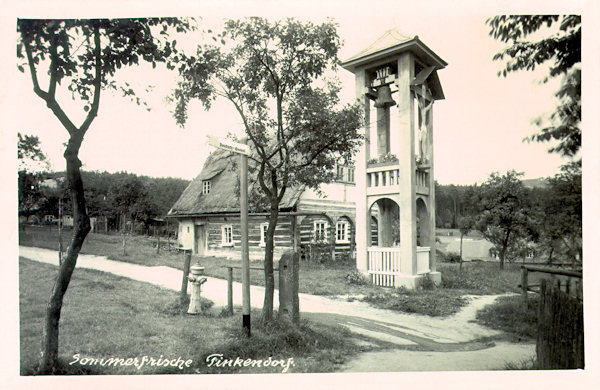 On this picture postcard we see the bell tower standing between the houses in the centre of the village. To-day the tower is beautifully renewed, but the timbered house behind of it does no more exist.