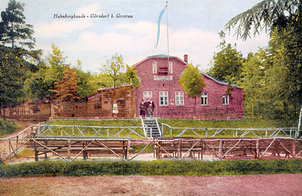 This picture postcard of 1931 shows the house of the inn „Hahnbergbaude“ the ruins of which, overgrown by the forest, till now you may see at the northern slope of the Sedlecký Špičák hill.