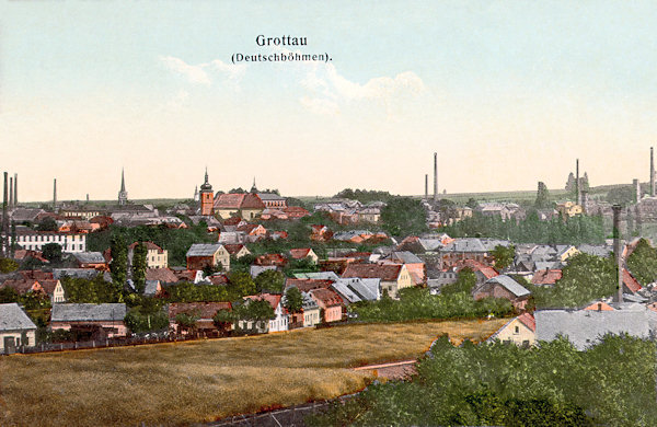 This picture postcard shows the view of the town from the south. In the foreground there are the houses of Donín village, most prominent in the town is the church of St. Bartholomew and to the left of it the less prominent tower of the Protestant church.