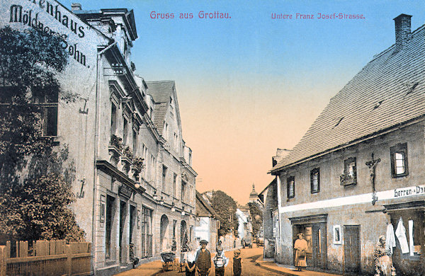 On this picture postcard from the years between the wars we see the lower part of the Ulice 1. Máje-street leading from the bridge over the Nisa-river to the Horní náměstí-square. After World War Two the houses on its right side were demolished and now there is a small park..