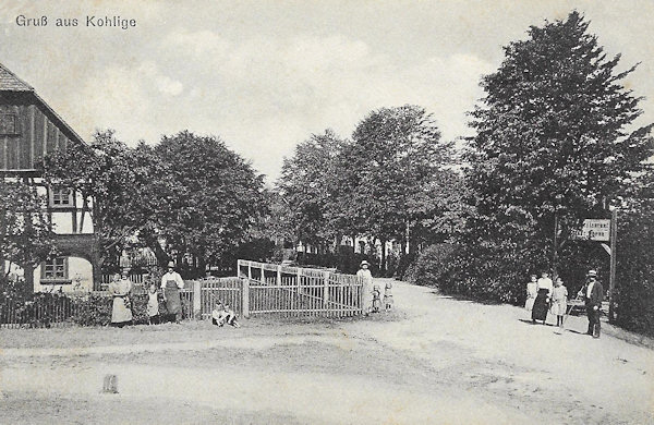 This postcard shows the crossroads in front of the Golden Pheasant Inn, hidden behind the trees on the right. The house on the left is now completely rebuilt.